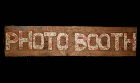 Vintage looking photo booth sign on black backgroundの写真素材