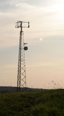 A cell phone tower with a grass base.