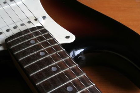 A close up of a guitar neck.