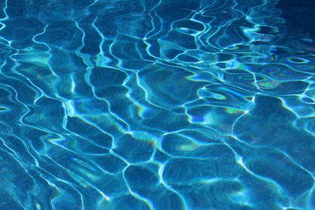 A swimming pool bottom cast in bright sunlight.の写真素材