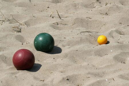 A game of bocce ball played in sand, at the beach.の写真素材
