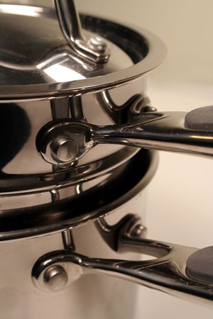 A close up of a stack of stainless steel pots.の写真素材