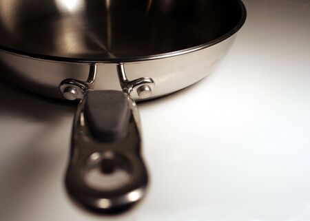 A stainless steel frying with the handle facing the viewer.の写真素材