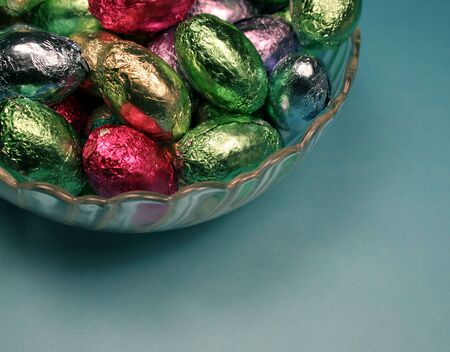 A bowl of foil chocolate Easter eggs.の写真素材