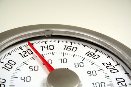 A close up of a weight scale set at 128.の写真素材