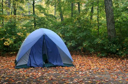 A tent sitting in a campsite in early autumn.の写真素材