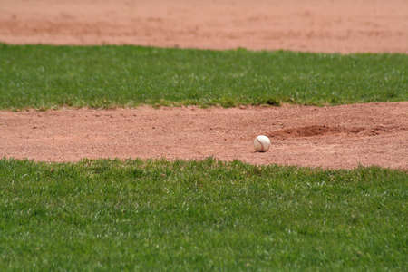 A baseball sitting in front of the pitchers mound.の写真素材