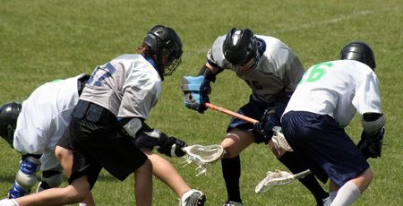 A lacrosse scrum featuring four players.の写真素材