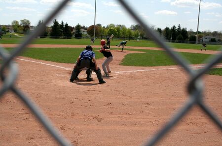 A view through the chain link fence at a baseball game.の写真素材