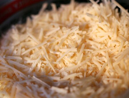 Grated asiago cheese shot with a shallow depth of field.の写真素材