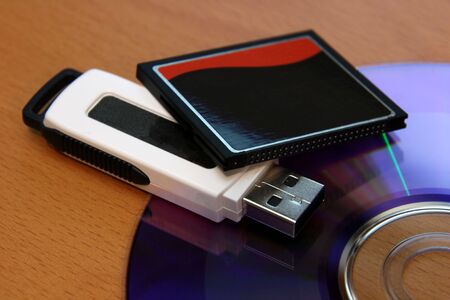 Three different pieces of media storage. (USB stick, compact flash and a DVD)の写真素材