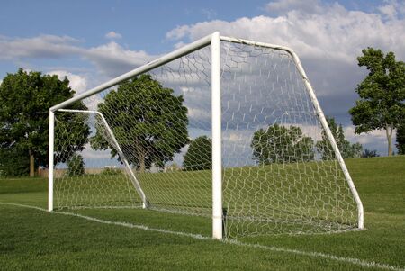 A view of a net on a vacant soccer pitch.の写真素材