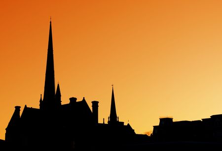 The spires of a cathedral against an orange sky.の写真素材