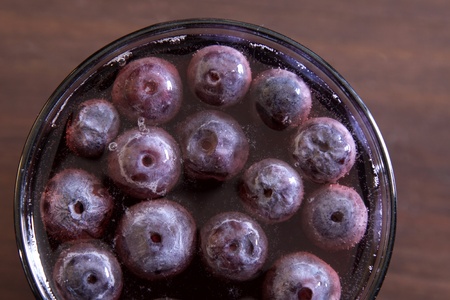 A shot of grape juice with grapes floating in it. の写真素材