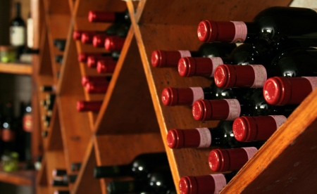 A buch of wine bottles in a rack in a wine cellar.の写真素材