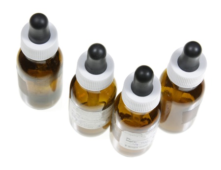 Four dropper bottles with naturopathic medicine in them.の写真素材