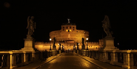 The towering Castel Sant'Angelo (Mausoleum of Hadrian) in Rome, Italy.  Shot at night from Ponte Sant Angelo.のeditorial素材