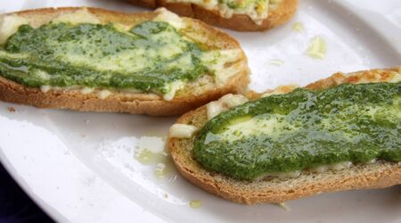 Delicious pesto and cheese toast, made with olive oil from the Liguria region of Italy. の写真素材