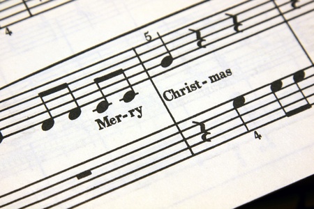 Merry Christmas text on a sheet of music.の写真素材