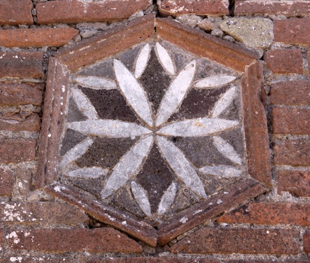 A brick decoration in the wall in the ruins of the Roman city of Pompeii.  It was completely buried by an eruption of Mount Vesuvius in AD 79.の写真素材
