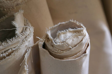 Several rolled up sheets of canvas.の写真素材
