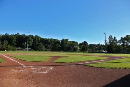 A wide angle view of baseball field shot early in the morning.