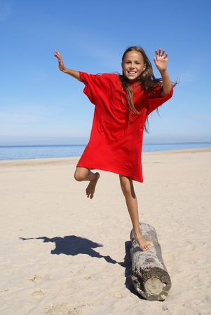 Cheerful preteen girl on a beachの写真素材