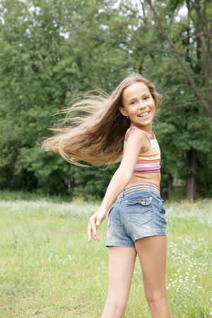 Happy preteen girl running outdoorsの写真素材