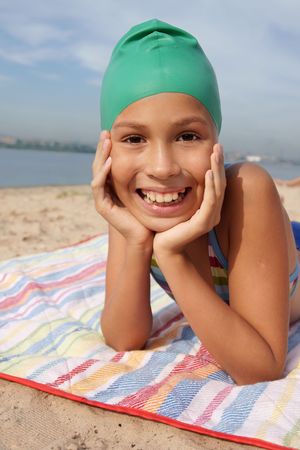 Preteen girl enjoying sun-bath on sea beachの写真素材