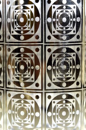Closeup on gold geometric shapes on a glass for background, abstract