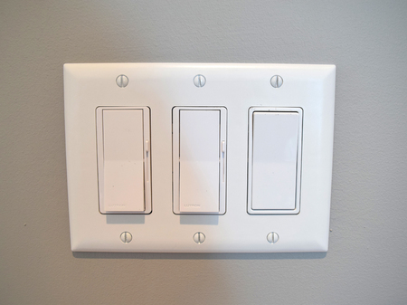Modern light switch in home on wallの写真素材