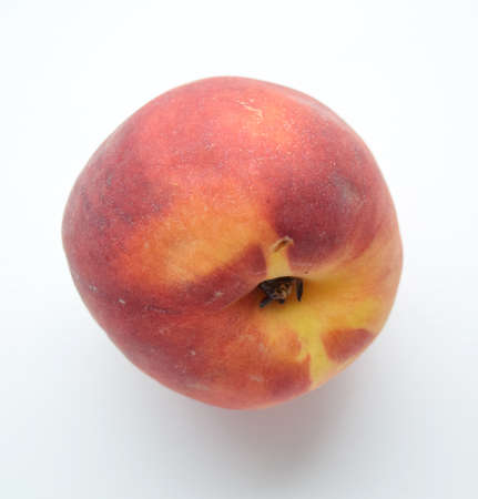 Ripe red peach on isolated white backgroundの写真素材