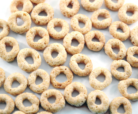 Whole weat circular cereal Os on white background