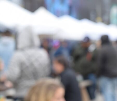 Blurry picture of people milling about at a bar outside (blurred for background use)の写真素材