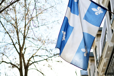Quebec flag in Montreal billowing in the breeze outsideの写真素材