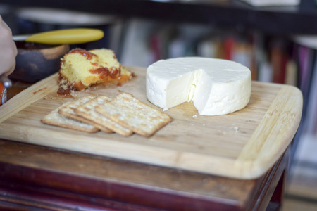 Traditional Brazilian cheese board (cheese from Minas Gerais) breakfast with wheat crackers, and...
