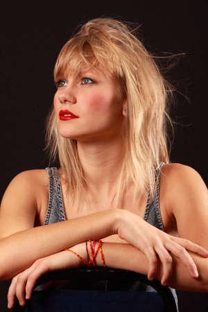 Low-key photograph of an attractive blonde haired young woman