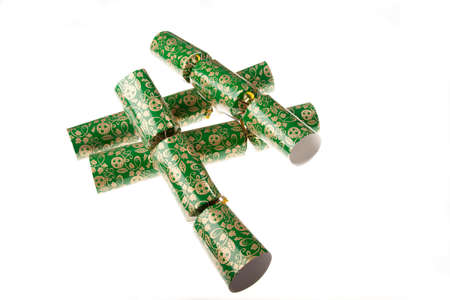 Four green christmas crackers isolated aagainst a white backgroundの写真素材