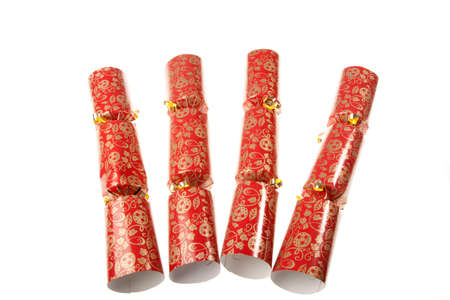 Four red christmas crackers isolated against a white backgroundの写真素材