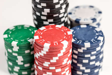 Close up shot of five piles of different coloured gaming chips isolated against a white backgroundの写真素材