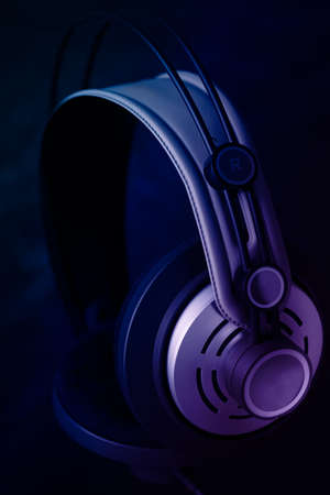 Hi fi headphone on a dark background with blue and purple lights