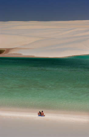 Tourists in lagoons surrounded by dunes in the LenÃ§ois Maranhenses National Park, MaranhÃ£o, Brazilのeditorial素材