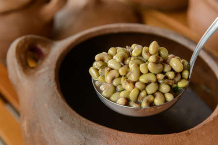 Green beans with blurred clay pots in the background. Traditional cuisine from northeastern Brazil.