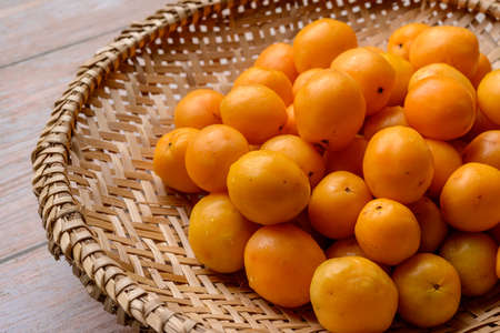 Brazilian fruit caja in the straw basket.の写真素材