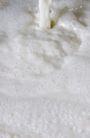 Fresh milk. Bubbles forming scene background.