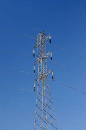 Electrifying posts with orange sunset sky background.の写真素材