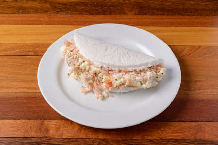 Tapioca on white plate on wooden table. Brazilian food.の写真素材