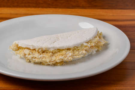 Tapioca on white plate on wooden table. Brazilian food.の写真素材