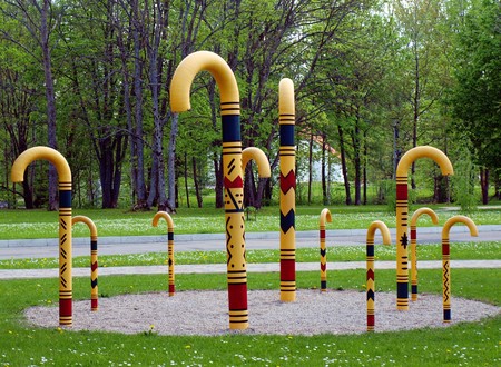 Square with several carved man-sizes walking-sticks as a monumentの写真素材