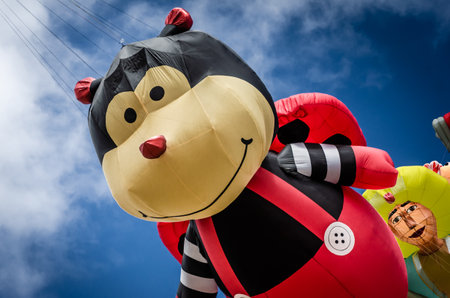 Giant flying ladybird cartoon character kite at the Summer Southsea kite festival, Portsmouth, UKのeditorial素材
